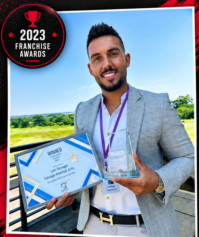 Lee Savage holding his Disruptive Franchisor of the Year award at the 2023 Franchise Awards