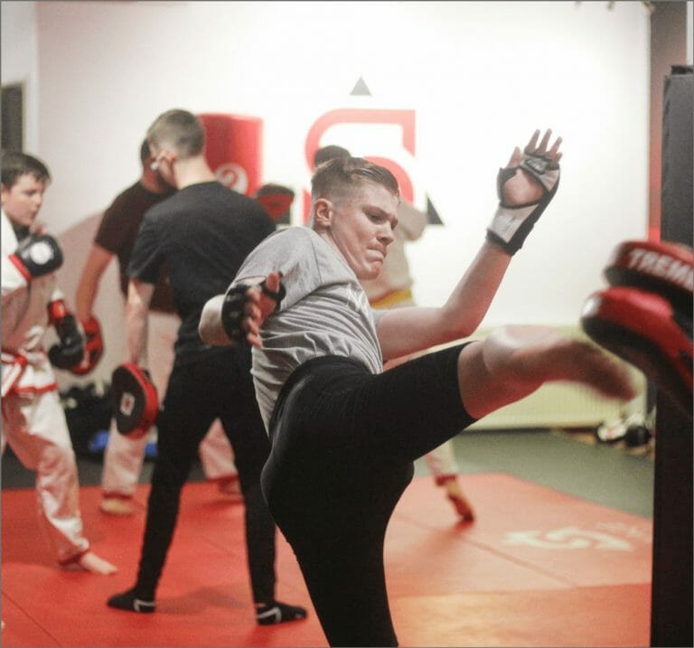 Adults training in a kickboxing class